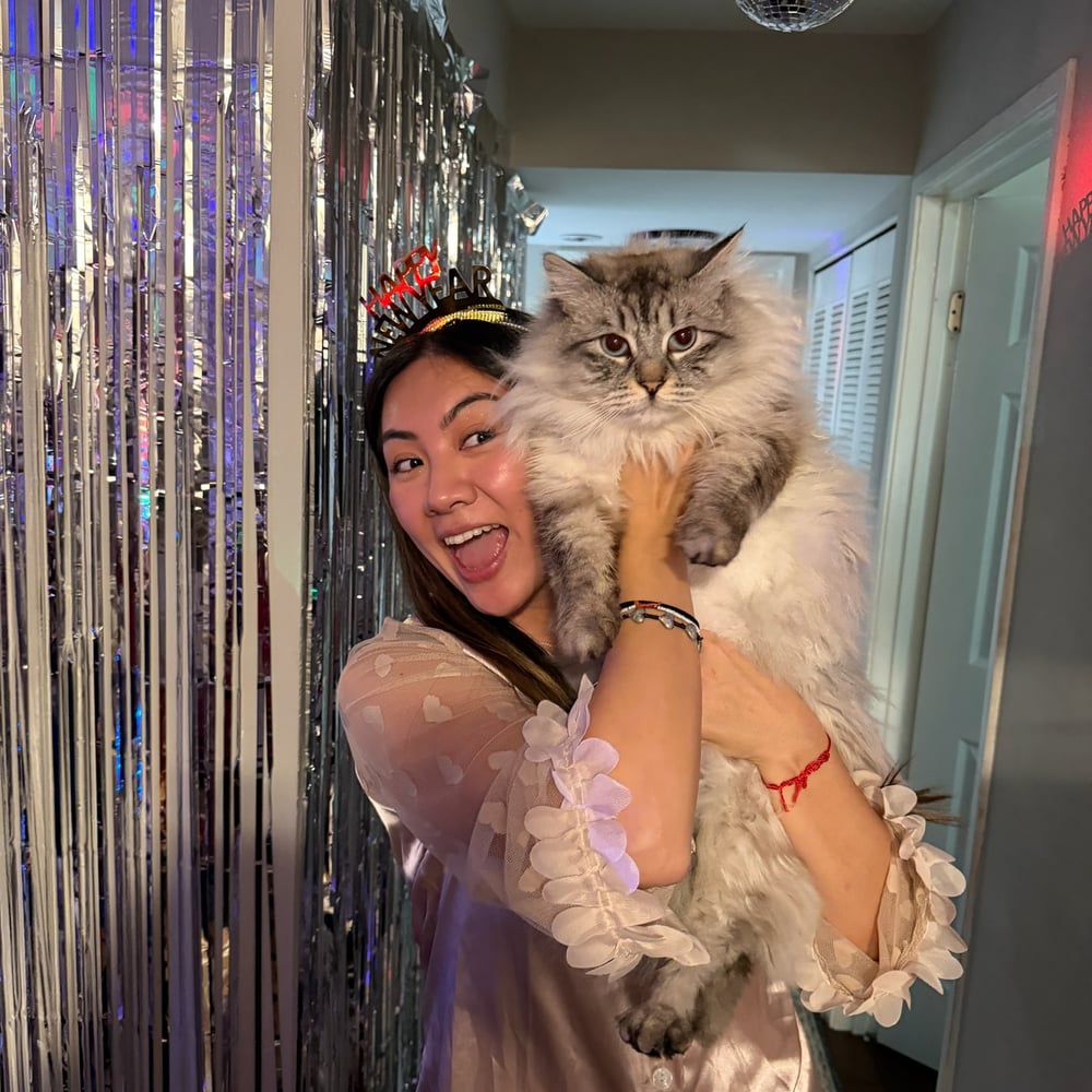 Irena happily holding her fluffy cat
